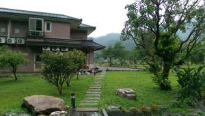 a house with a garden in front of it at Seasons Inn in Jiaoxi