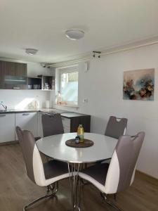 a dining room with a table and chairs in a kitchen at Apartments Lajk in Lesce