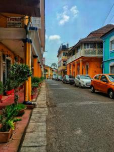 a street with cars parked on the side of the road at Assagaon Studio at Kiara Homes in Assagao