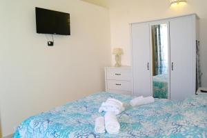a bedroom with a bed with towels on it at Lost In Amalfi in Amalfi