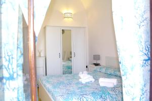 a bedroom with a bed with towels on it at Lost In Amalfi in Amalfi