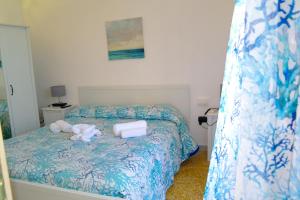 a bed with two towels and a stuffed animal on it at Lost In Amalfi in Amalfi