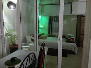 a room with a bedroom with a bed and a mirror at BiJOY VILLA in Guwahati