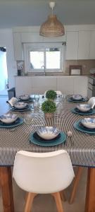 a table with plates and dishes on it in a kitchen at Casa de Melides in Melides