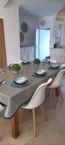 a dining room table with plates and glasses on it at Casa de Melides in Melides
