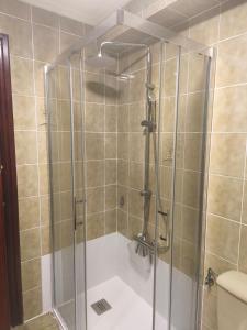 a shower with a glass door in a bathroom at Ezpeleta Palace in Berriozar +13 photos