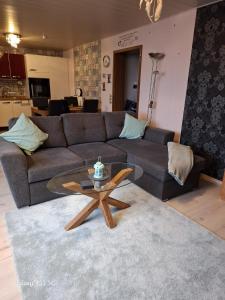 a living room with a couch and a glass table at Ferienwohnung Seeblick in Langweiler +15 photos