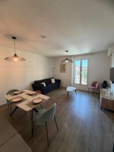 a living room with a couch and a table at Elégance du Golfe in Vallauris