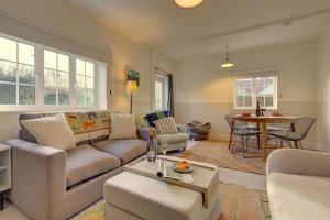 a living room with a couch and a table at Rose Cottage in Docking