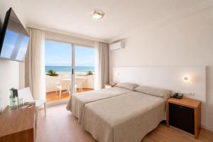 a bedroom with a bed and a view of the ocean at Hotel RH Riviera - Adults Only in Gandía