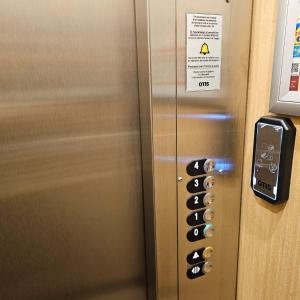 a elevator door with a bunch of buttons on it at Hotel du Commerce et de Navarre in Lourdes
