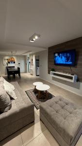 a living room with a couch and a table and a tv at Departamento centro Rio Cuarto con Cochera in Río Cuarto +2 photos