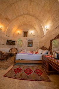 a bedroom with a large bed in a stone room at Born Hotel in Ürgüp