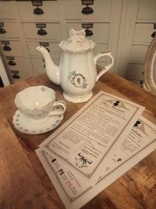 a table with a teapot and a tea set at Chez Madame in Dijon