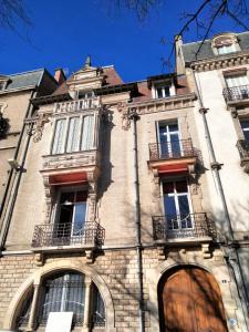 a large brick building with windows and balconies at Chez Madame in Dijon