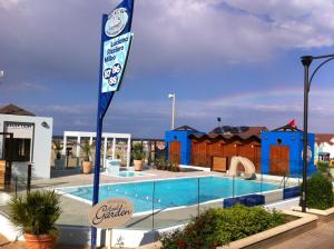 a swimming pool at a resort with a flag at Vibe Hotel in Cattolica