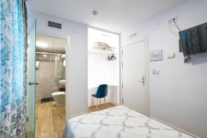 a small bedroom with a bed and a bathroom at New Hostal Cabañas in Carboneras de Guadazaón +51 photos