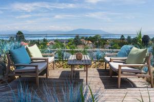 a group of chairs and a table on a patio at YOTEL Geneva Lake in Founex +39 photos