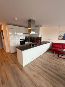 a kitchen with a counter and a red couch at Palaceblick in Schleswig +2 photos