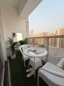 a balcony with a table and chairs on a balcony at Fifth Heaven Studio at Spectrum Mall in Noida +14 photos