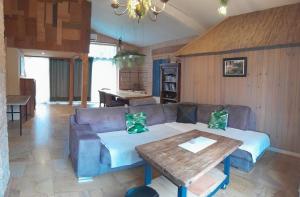 a living room with a couch and a table at Canopée in Saint-Nabord