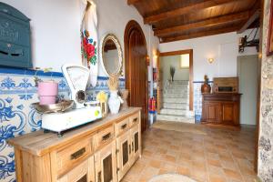 a kitchen with a counter with a sink and a mirror at New Hostal Cabañas in Carboneras de Guadazaón