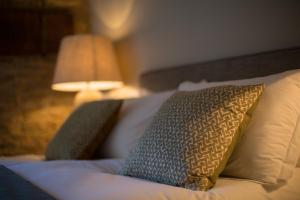 A bed or beds in a room at The Angel at Burford 