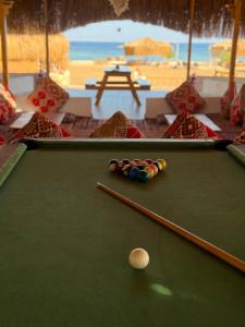 a green pool table with a cue ball on it at Relax Beach Camp in Nuweiba