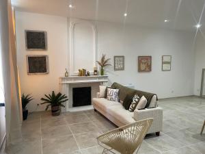 a living room with a couch and a fireplace at Appartement avec mini suite vue Cathédrale in Cavaillon