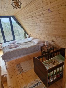 a bedroom with a bed in a wooden cabin at Cozy Cottage B in Kutaisi