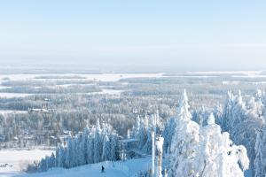 a person is skiing down a snow covered slope at Break Sokos Hotel Tahko in Tahkovuori
