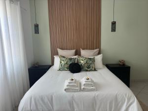 a bedroom with a bed with towels on it at Poseidon Beachfront Holiday Home in Swakopmund