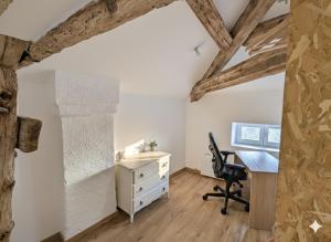 an attic office with a desk and a chair at Studio spacieux avec bureau - Calme & Proche Lyon in Irigny