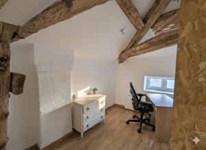 an attic office with a desk and a chair at Studio spacieux avec bureau - Calme & Proche Lyon in Irigny