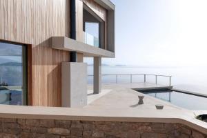 a house with a view of the ocean at VILLA ODISSOS - Private Paradise with 2 infinity pools & Sea access in Sivota