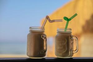 two glass mason jars filled with a drink at Relax Beach Camp in Nuweiba