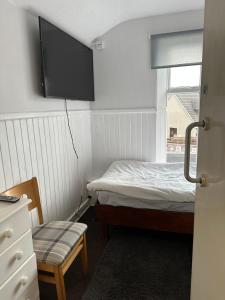 a small bedroom with a bed and a window at The Staging Post in Aberdeen +4 photos
