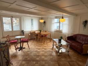 a living room with a couch and a table at Hotel Central - Self Check-in in Luchsingen