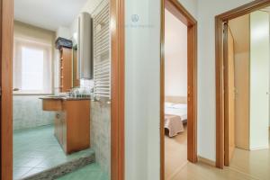 a bathroom with a sink and a toilet in a room at Domo Mea-House Live Express in Quartu Sant'Elena +36 photos