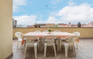 a table and chairs sitting on a balcony at Domo Mea-House Live Express in Quartu Sant'Elena
