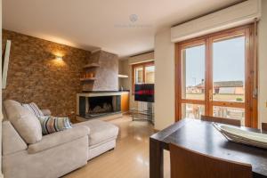 a living room with a couch and a fireplace at Domo Mea-House Live Express in Quartu Sant'Elena