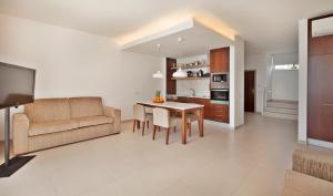 a living room with a couch and a table at Sao Rafael Holidays in Albufeira