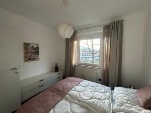 a bedroom with a bed and a window at Faraway Homes Studio Bruck #11 in Bruck an der Mur