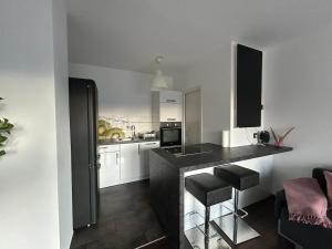 a kitchen with a counter and a sink and a stove at Faraway Homes Studio Bruck #11 in Bruck an der Mur