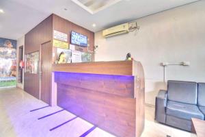 a bar in a waiting room with a leather chair at Sai Arya Residency By The Avyaan in Mangalore +17 photos