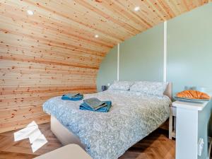 a bedroom with a bed with a wooden ceiling at 1 Bed in Matlock oc-96256 in Crich