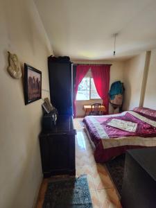 a bedroom with two beds and a window at Cozy Stay in Baabda