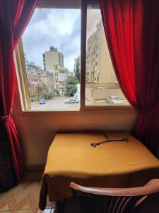 a window with a table in a room with a view at Cozy Stay in Baabda
