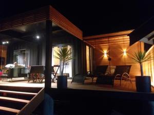 a house with a porch with chairs and a table at Chalé Container Lufre in Santo Antônio do Pinhal +13 photos