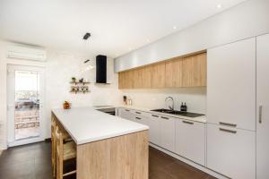 a kitchen with white cabinets and a white counter top at Villa Kamelicina in Vinišće +53 photos